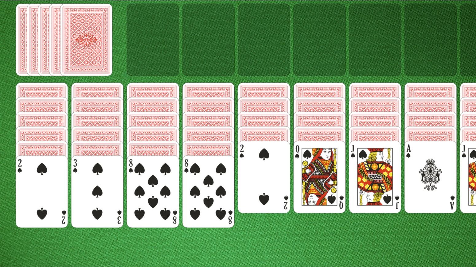 Spider Solitaire cards on a green table